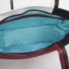 binnenkant leren tas zwart wit bruinrood met turquoise voering en twee ritsvakken mobiel en sleutels